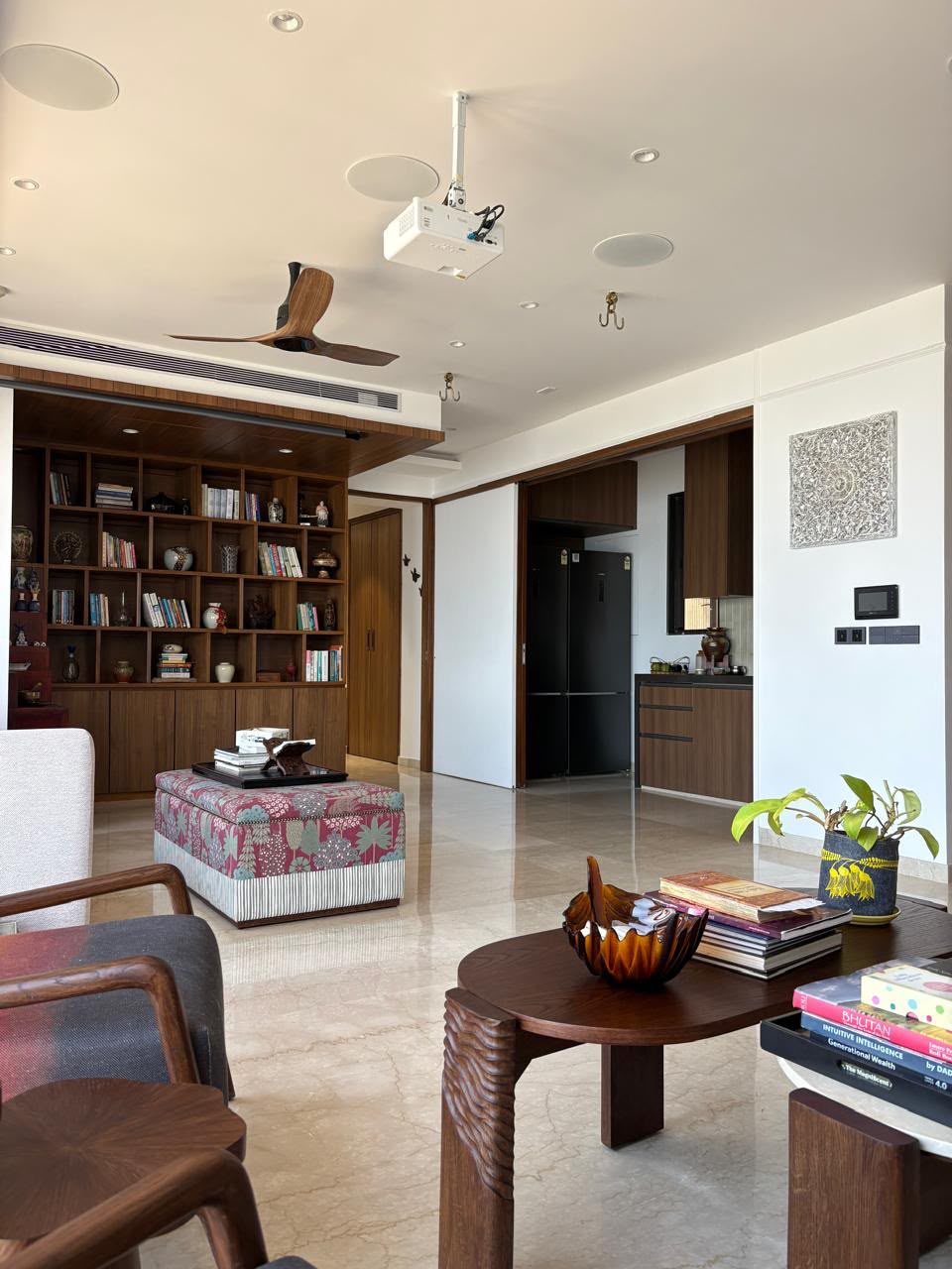 Dining area with a dark table and large artwork, from a Laxmi Decorz project