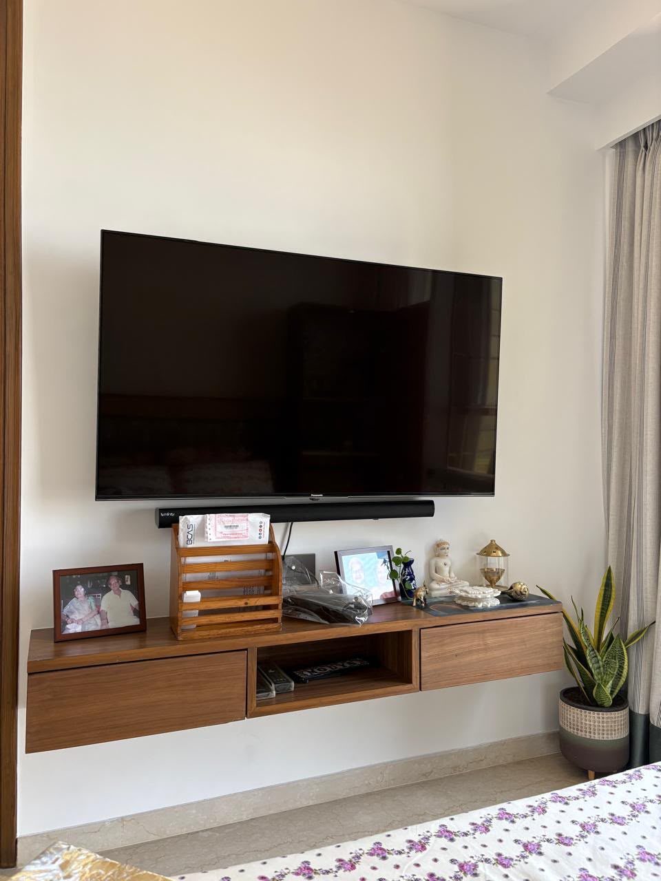 Finished living area with wooden bookshelves and joinery, from a Laxmi Decorz project